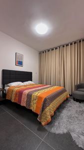 Comfortable bedroom with plush rug and warm accent bedding