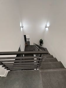 Modern staircase with sleek dark treads and accent lighting