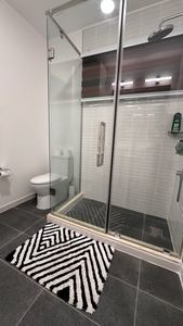 En-suite with walk-in glass shower and designer floor tiling