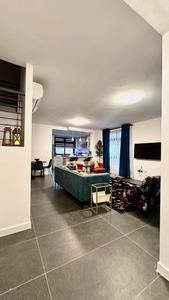 Living area with wall-mounted TV and modern furnishings