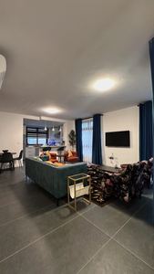 Inviting lounge with green sofa and entertainment setup