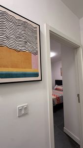 Elegant corridor with framed art and bedroom access